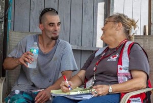 Jacob Hoffpauir meets with Red Cross volunteer Linda Jones from Midwest City, Oklahoma who is part of an integrated response team providing mental health and health services to people affected by the flooding. Photo by: Marko Kokic/American Red Cross