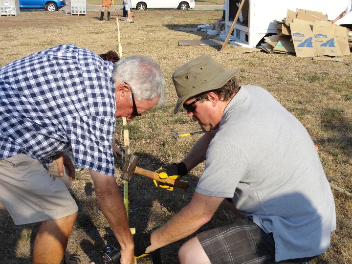 Driving stakes to lay out the garden beds, 2011